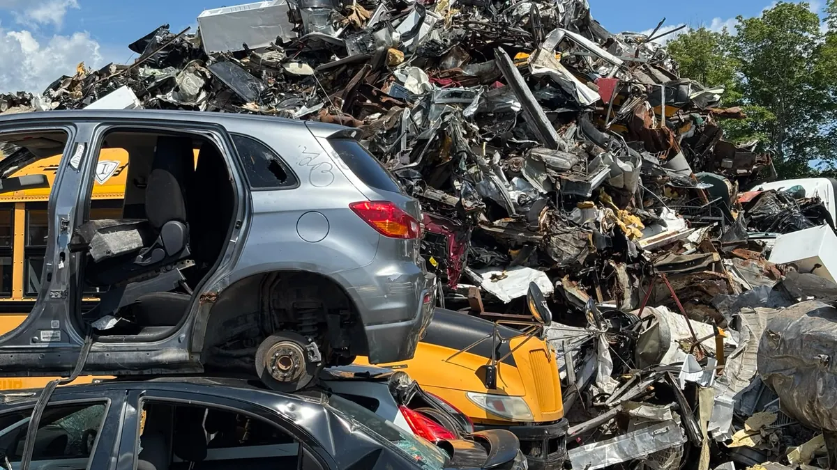 Mountain of automotive scrap metal and stripped vehicle shells at the recycling centre